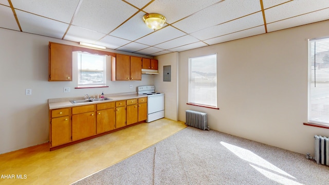 kitchen with light countertops, a sink, radiator heating unit, and white range with electric cooktop