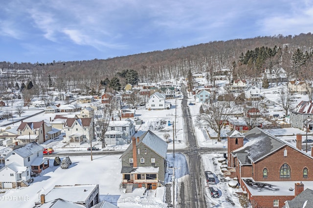 snowy aerial view with a residential view