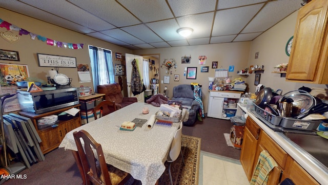 dining area featuring a drop ceiling