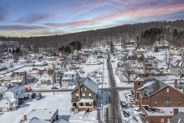 snowy aerial view with a residential view