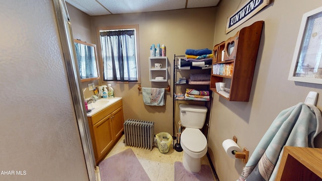 bathroom featuring tile patterned floors, vanity, toilet, and radiator