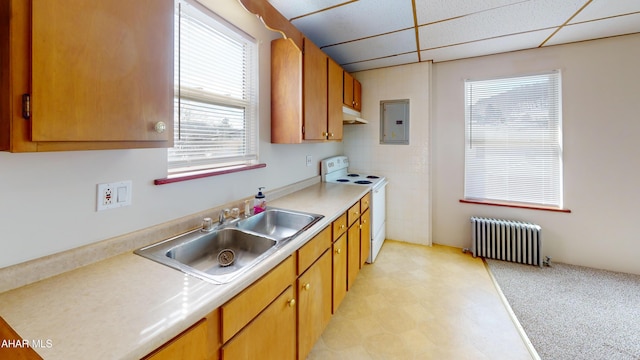 kitchen with a sink, electric stove, light countertops, electric panel, and radiator