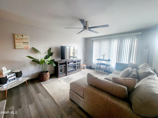 living area with ceiling fan and wood finished floors