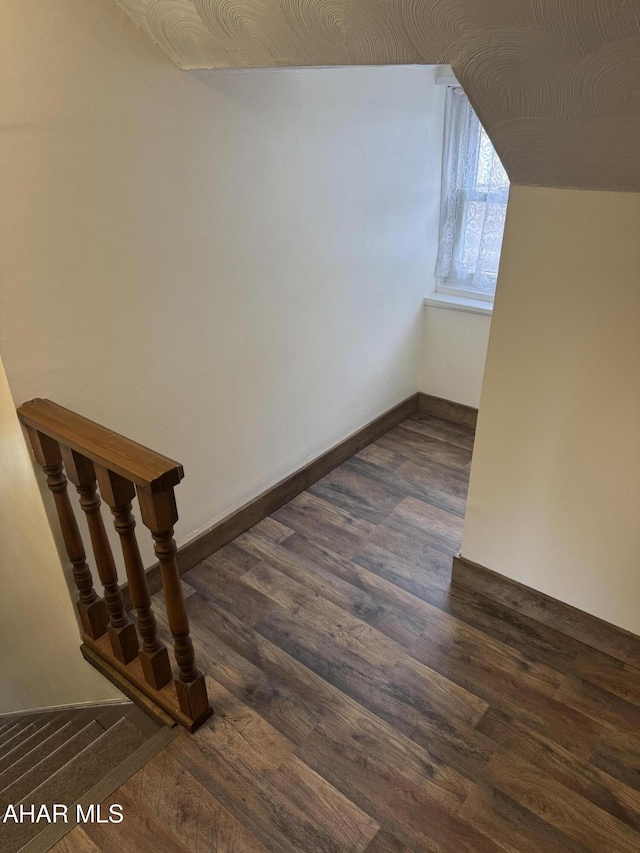 bonus room featuring dark wood-type flooring