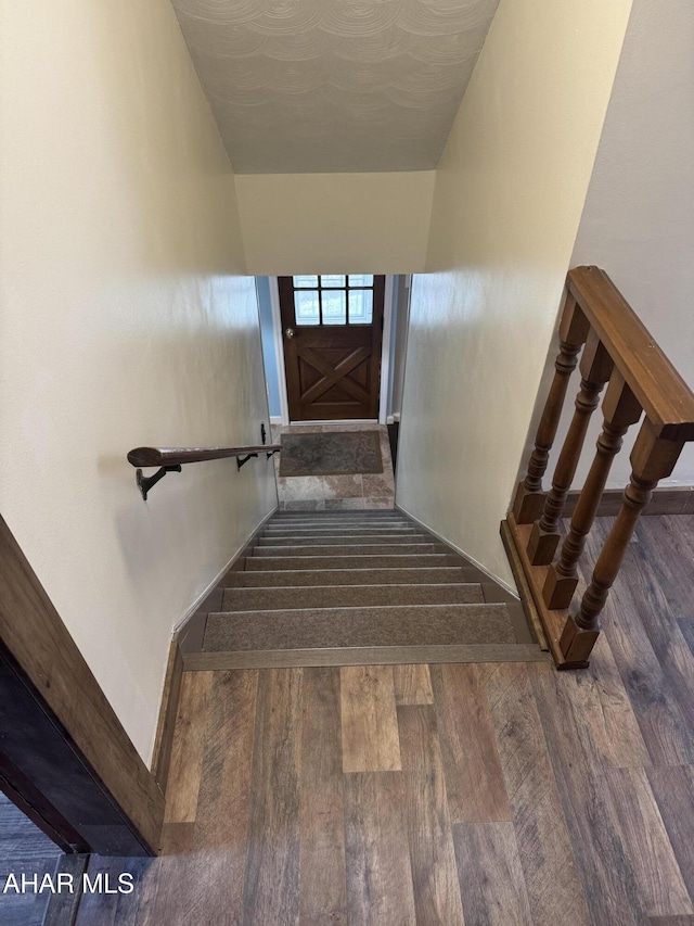 stairs with hardwood / wood-style floors