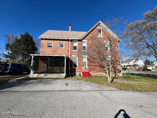 view of front of house featuring a sunroom