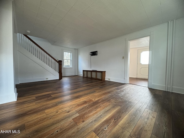 unfurnished living room featuring dark hardwood / wood-style floors and radiator