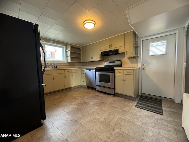 kitchen with sink, cream cabinets, and appliances with stainless steel finishes