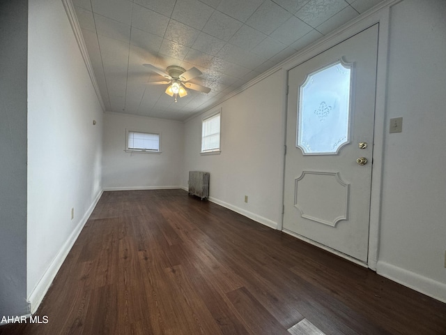 entrance foyer featuring crown molding, ceiling fan, and dark wood-type flooring