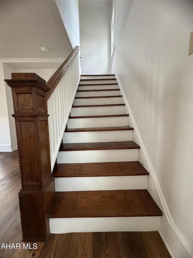 stairs featuring wood-type flooring