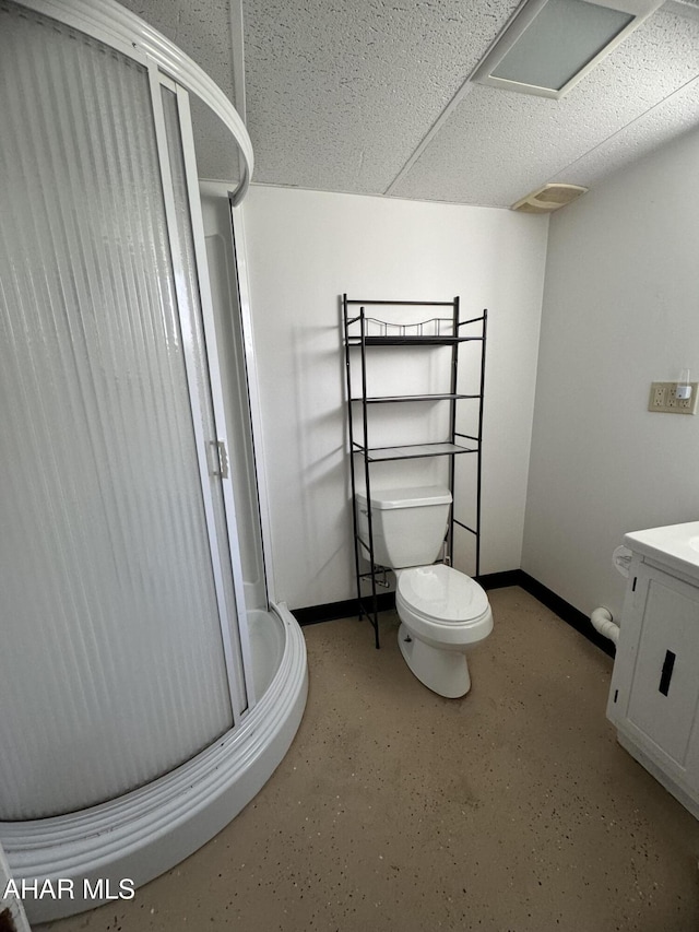 bathroom featuring toilet, vanity, and walk in shower