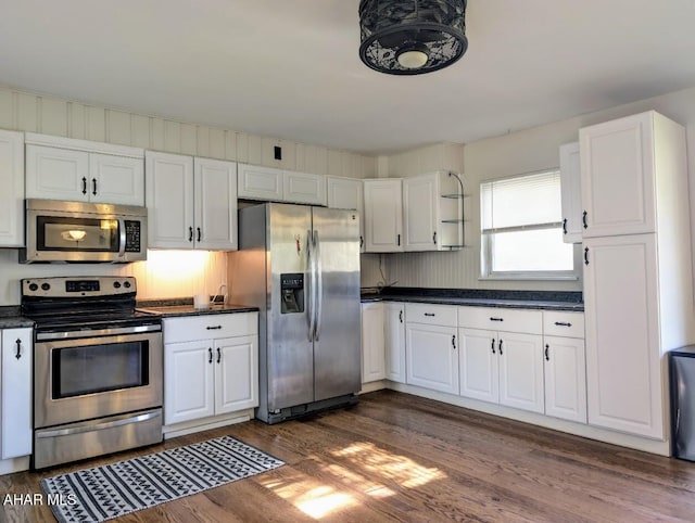 kitchen featuring white cabinets, dark hardwood / wood-style floors, and appliances with stainless steel finishes