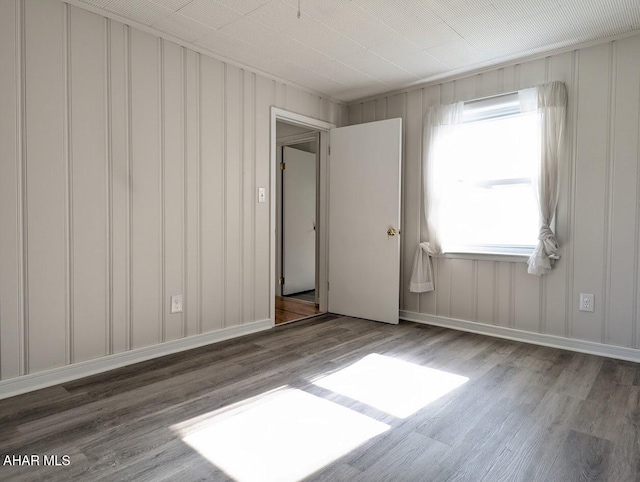 spare room with wood-type flooring