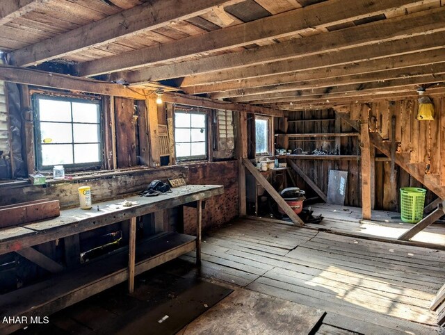 miscellaneous room featuring a workshop area and wood ceiling