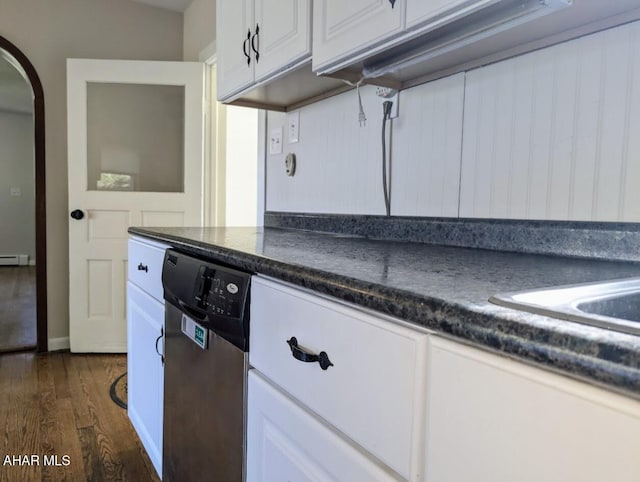 kitchen featuring white cabinetry, dark hardwood / wood-style flooring, stainless steel dishwasher, and a baseboard radiator