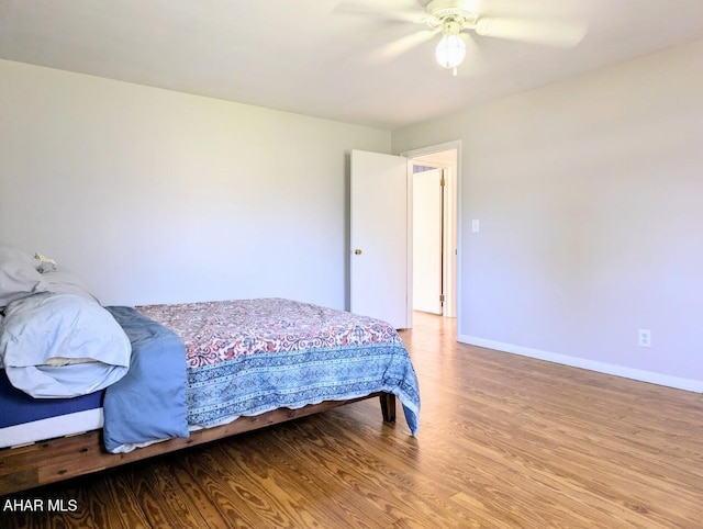 bedroom with light hardwood / wood-style floors and ceiling fan