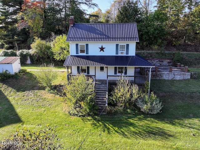 back of property featuring a porch and a yard