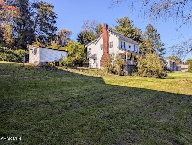 view of yard featuring covered porch and an outdoor structure