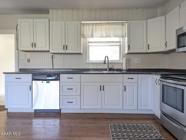 kitchen with white cabinetry, sink, dark hardwood / wood-style floors, and appliances with stainless steel finishes