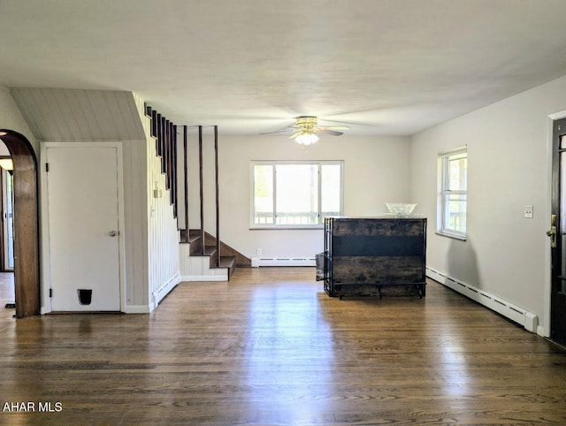 unfurnished living room featuring dark hardwood / wood-style flooring and a baseboard radiator