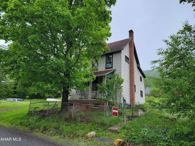 575 Thomastown Rd, Tyrone, PA 16686 - view of property exterior featuring a chimney and a gate