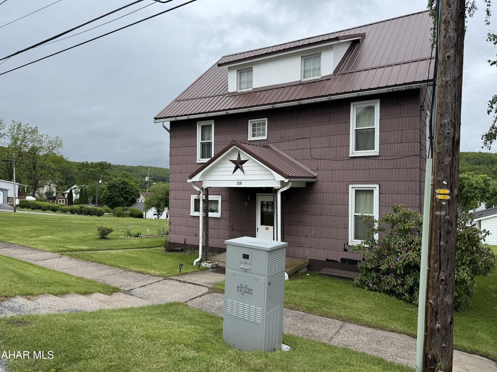 308 Hopkins St, Irvona, PA 16656 - american foursquare style home featuring a front yard and metal roof