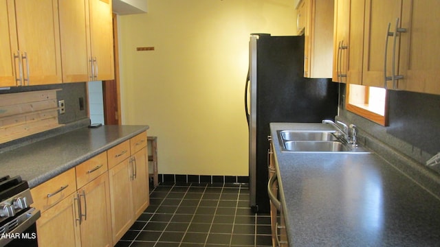 kitchen with sink, decorative backsplash, dark tile patterned floors, and appliances with stainless steel finishes