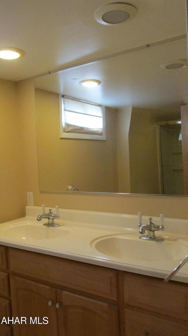 bathroom featuring vanity and an enclosed shower