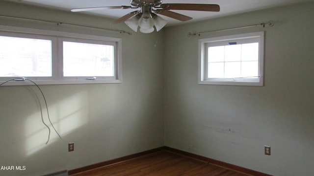 empty room featuring dark hardwood / wood-style flooring and ceiling fan