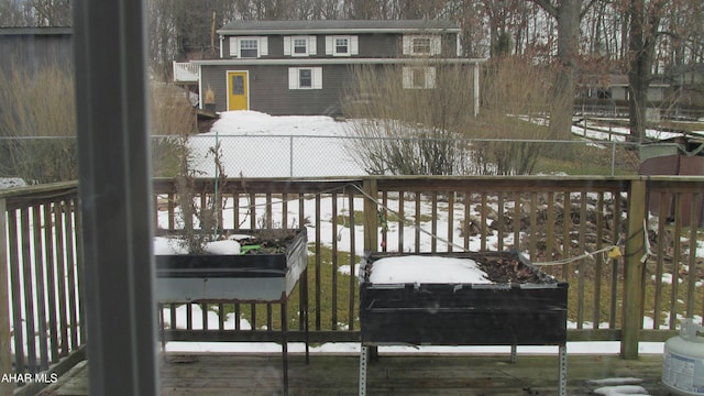 snow covered deck with grilling area