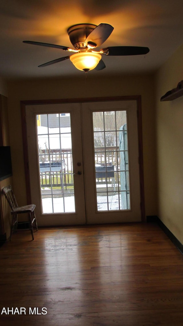 entryway with dark wood-type flooring, french doors, and ceiling fan