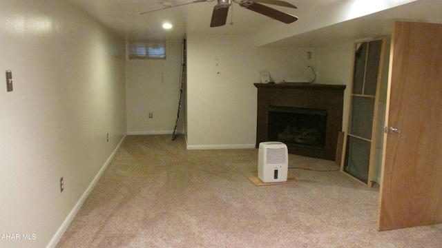 unfurnished living room featuring light colored carpet and ceiling fan