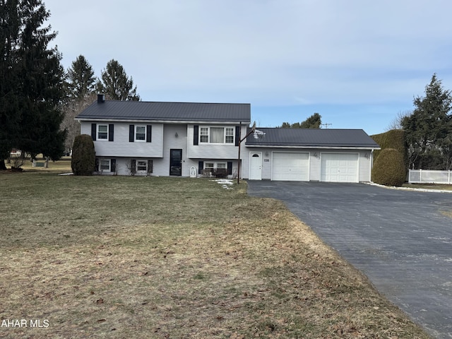 view of front of property with a garage and a front lawn