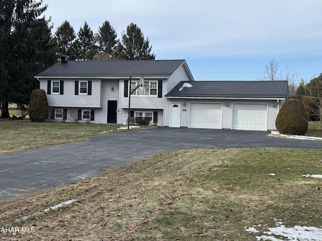 bi-level home with a garage and a front yard