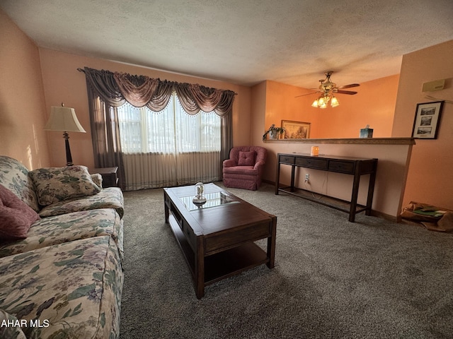 living room with ceiling fan, a textured ceiling, and dark colored carpet