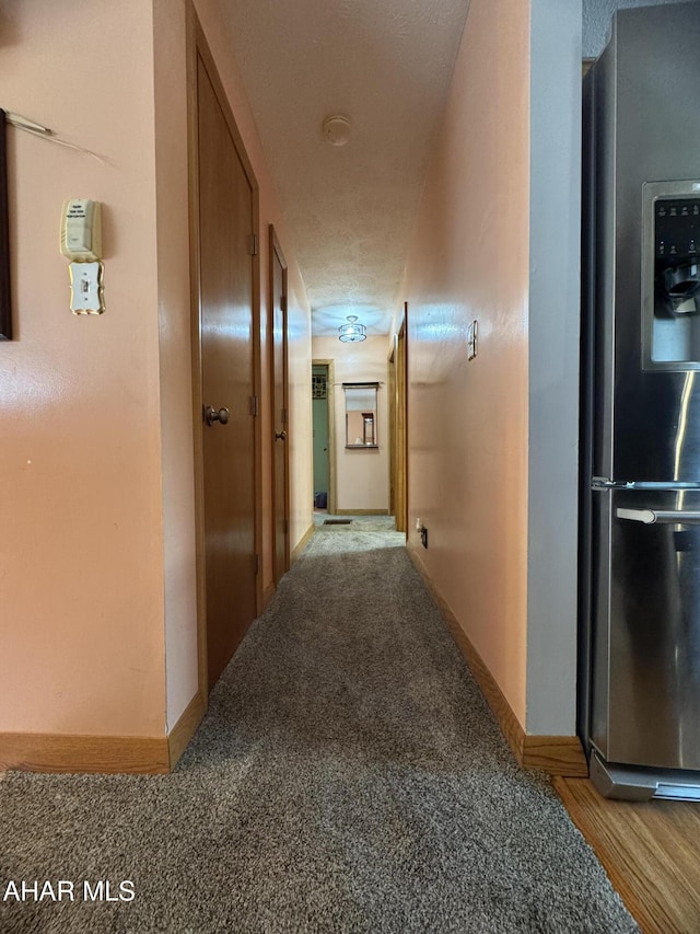 hallway with light colored carpet