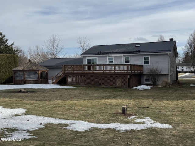 snow covered property with a yard, a gazebo, and a wooden deck