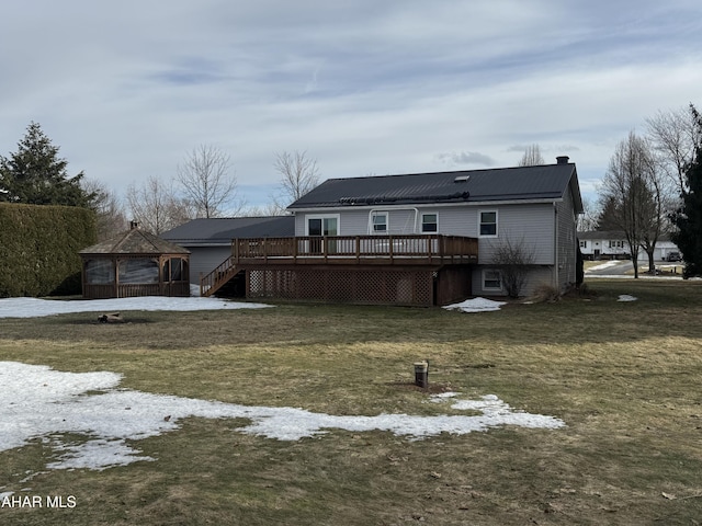 rear view of house featuring a gazebo, a yard, and a wooden deck