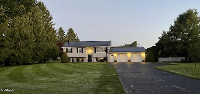 view of front of property featuring a yard and a garage