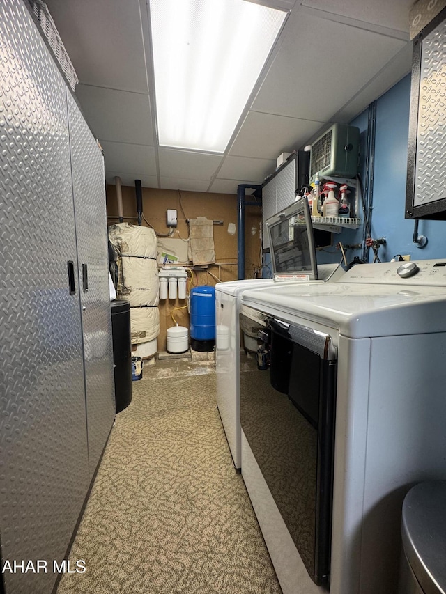 clothes washing area with washing machine and dryer