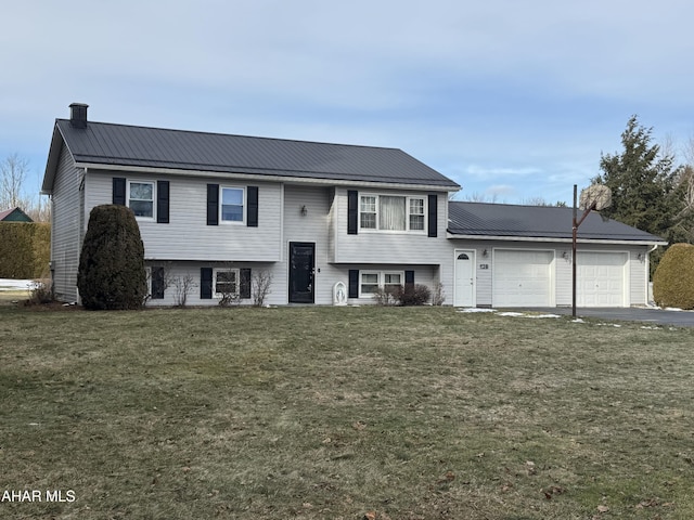 bi-level home with a garage and a front lawn