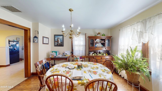 dining space with an inviting chandelier and visible vents