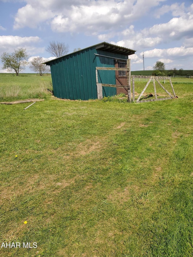 view of pole building featuring a yard and a rural view