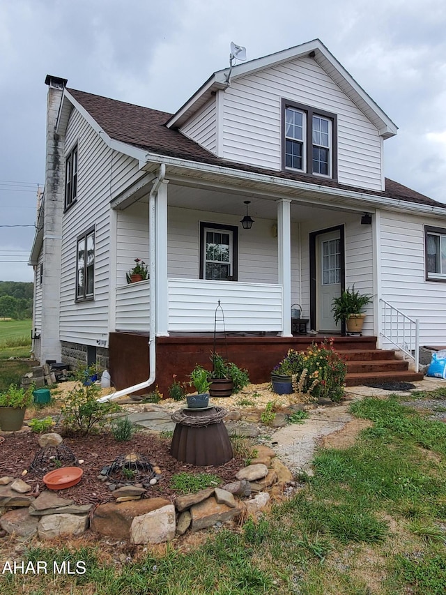 view of front facade featuring covered porch and roof with shingles