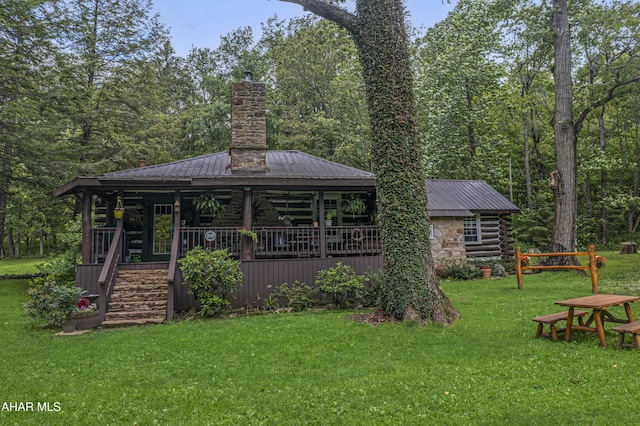 166 Mink Rd, Boswell, PA 15531 - rear view of house with a chimney, a lawn, a metal roof, a porch, and log exterior