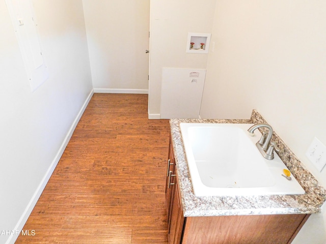 115 Spruce St, Smithmill, PA 16680 - laundry room featuring washer hookup, wood finished floors, a sink, and baseboards