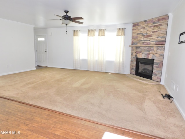 115 Spruce St, Smithmill, PA 16680 - unfurnished living room with a ceiling fan, baseboards, a stone fireplace, carpet flooring, and crown molding