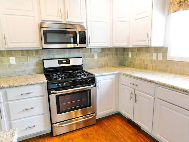 115 Spruce St, Smithmill, PA 16680 - kitchen featuring stainless steel appliances, white cabinetry, backsplash, and light stone countertops