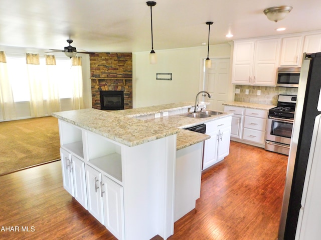 115 Spruce St, Smithmill, PA 16680 - kitchen with appliances with stainless steel finishes, a sink, open shelves, an island with sink, and ceiling fan
