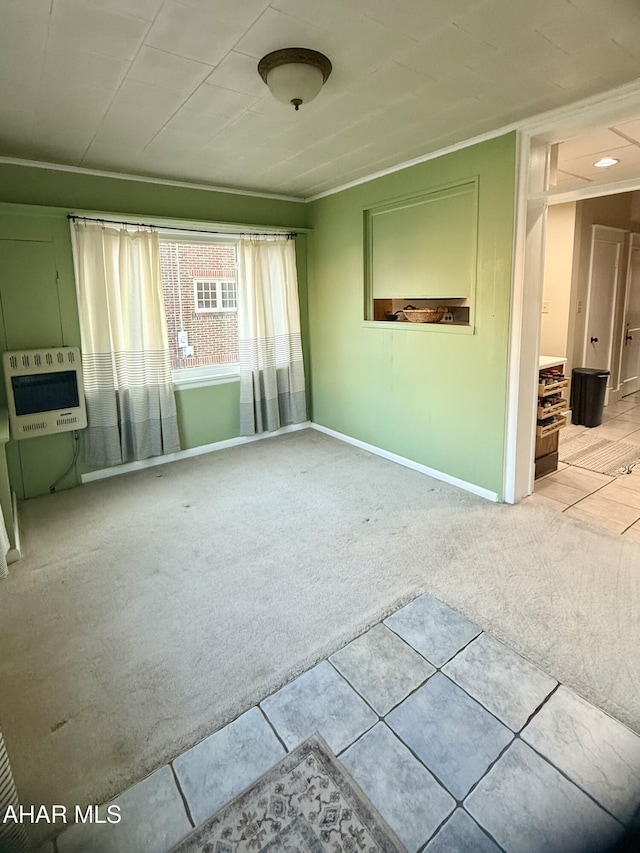 unfurnished living room featuring baseboards, heating unit, and carpet